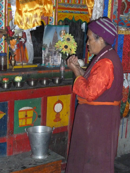 08 The nun lights incense and offers prayers to the Buddha