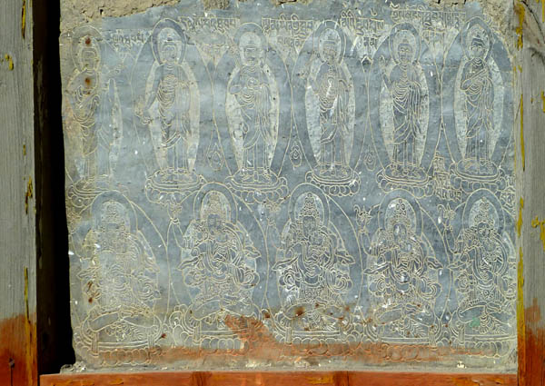 21 Tibetan 'saints' on a slate on a Mani Wall