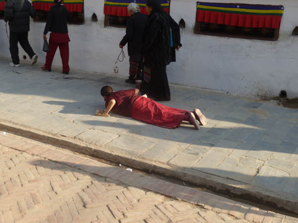 19 A prostrating Bhuddist monk