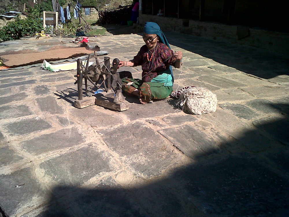 04 Spinner with her wool and spinning wheel