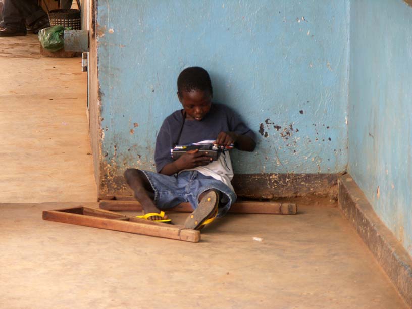 17 Mbaza waiting with his radio in front of Badat's Hardware where we get the Clinic supplies